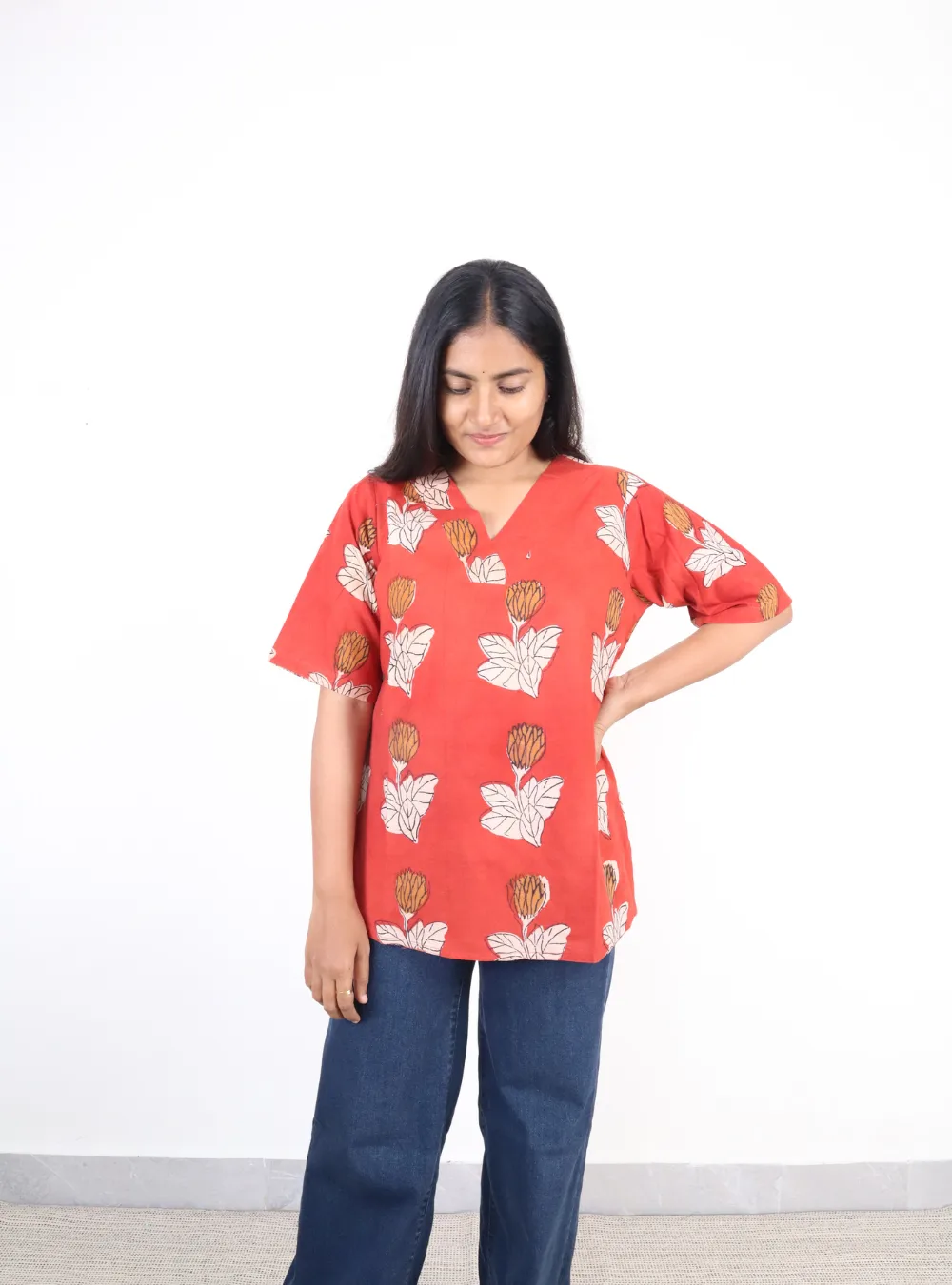 orange coloured floral print short kurti